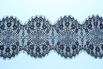 Black lace on light blue background, top view