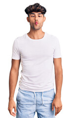 Obraz premium Young hispanic man wearing casual clothes making fish face with lips, crazy and comical gesture. funny expression.