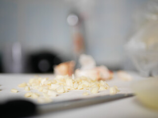 person slicing a garlic