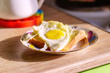 A common man's breakfast is a fried egg on a piece of bread