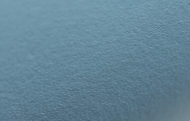 Light blue leather as background, closeup view