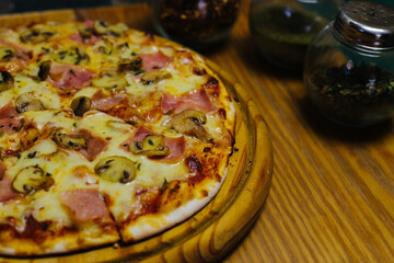 Delicious street pizza with some ingredients at side