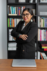 Mexican business woman standing with arms crossed looking at camera smiling