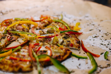 Delicious street pizza with some ingredients at side