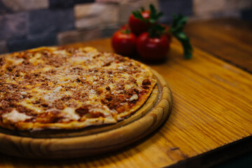 Delicious street pizza with some ingredients at side