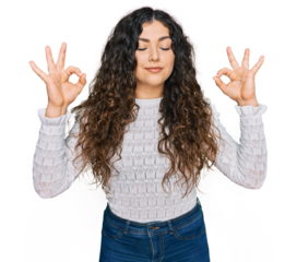 Young hispanic girl wearing casual clothes relax and smiling with eyes closed doing meditation gesture with fingers. yoga concept.