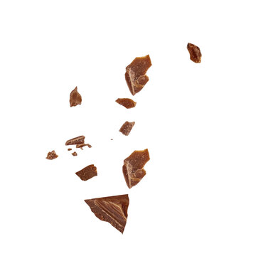 Flying chocolate  crumbs pieces isolated on white background. Broken choco crumbs  Top view. Flat lay.