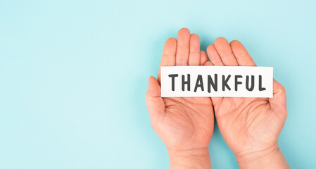 Thankful sign in hand, thank you, support, help and charity concept, positive attitude
- 780865466