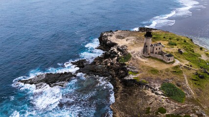 Natural background. A storm on an island in the ocean with a lighthouse.