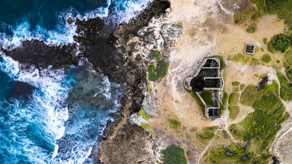 Natural background. A storm on an island in the ocean with a lighthouse.