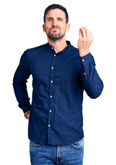 Young handsome man wearing casual shirt doing italian gesture with hand and fingers confident...