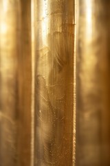 A soft-focused image capturing the intricate textures and patterns on a shimmering brass surface
