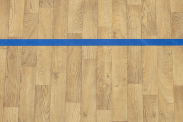 Wooden floor basketball, badminton, futsal, handball, volleyball, football, soccer court. Wooden floor of sports hall with blue marking lines on wooden floor indoor, gym court