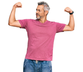 Middle age grey-haired man wearing casual clothes showing arms muscles smiling proud. fitness concept.