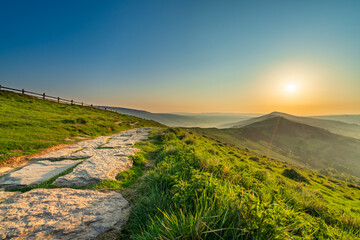Stone footpath and wooden fence leading a long The Great Ridge in the English Peak District - 780875054
