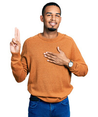 Young african american man wearing casual clothes smiling swearing with hand on chest and fingers...