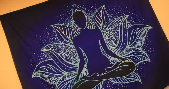yoga poster sitting in lotus position on video	
