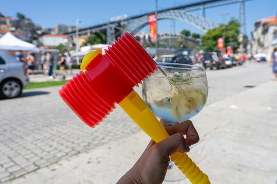 colorful plastic hammer with a porto tonic cocktail in Porto Portugal at sao joao festival saint john's day