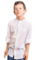 Cute blond kid wearing elegant shirt looking at the camera blowing a kiss on air being lovely and sexy. love expression.