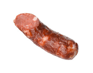 Piece of thin dry smoked sausage isolated on white