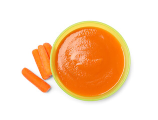 Obraz premium Delicious baby food in bowl and fresh carrots isolated on white, top view