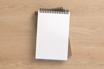 Notebook mockup. Two notebooks in a stack. Spiral notepad on wooden background