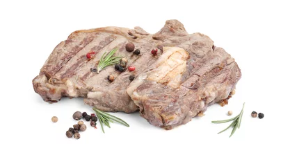 Schilderijen op glas Piece of delicious grilled beef meat, rosemary and peppercorns isolated on white © New Africa