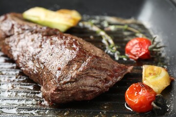 Delicious grilled beef meat and vegetables in pan, closeup