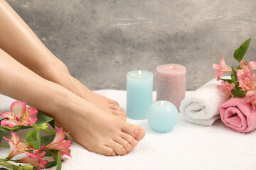Obraz na płótnie Canvas Woman with neat toenails after pedicure procedure on white terry towel, closeup