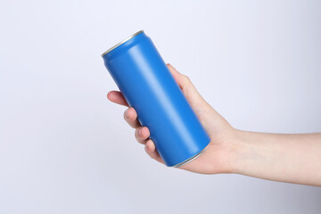 Woman with energy drink on light grey background, closeup