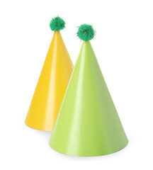 Two colorful party hats with pompoms isolated on white