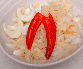Top view, Sauerkraut in a plate. Food with vitamin c. Healthy food for fitness. Perez chili sliced...