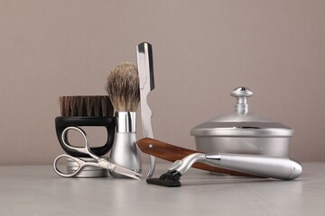 Moustache and beard styling tools on grey table
