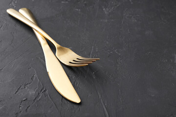 Beautiful cutlery set on black table. Space for text