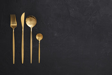 Beautiful cutlery set on black table, flat lay. Space for text