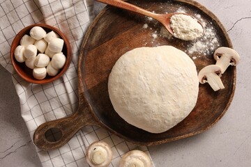 Pizza dough and products on gray textured table, flat lay