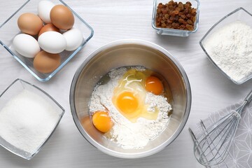 Making dough. Flour, eggs, sugar and raisins on white wooden table, flat lay