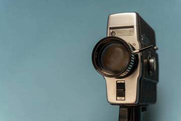 A close-up of a vintage movie camera shooting on 8 mm film from the 80s