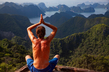 man in yoga pose in Ha Long bay  Vietnam