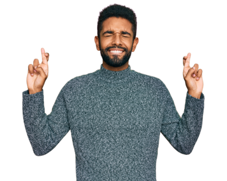 Young african american man wearing casual clothes gesturing finger crossed smiling with hope and eyes closed. luck and superstitious concept.