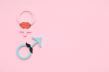 Female and male gender symbols on pink background