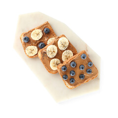 Board of toasts with peanut butter and fresh fruits on white background