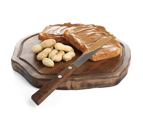  Wooden board of toasts with peanut butter and nuts on white background © Pixel-Shot