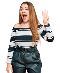 Young beautiful redhead woman wearing elegant clothes showing and pointing up with fingers number...