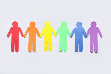 Colorful paper human figures on light background. LGBTQ concept