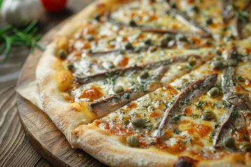 Fototapeten Delicious homemade Roman gourmet pizza with anchovies capers and oregano on wooden table © The Big L
