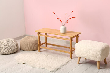 Interior of modern living room with coffee table and poufs