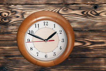 a clock with hands showing the time of 1 hour and 50 minutes. round clock