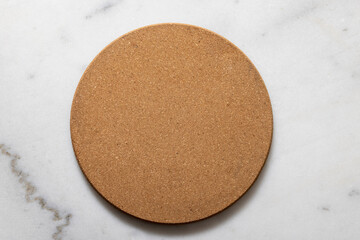 Round cork trivet for hot pans or plates on a marble counter