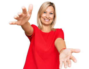 Middle age caucasian woman wearing casual clothes looking at the camera smiling with open arms for hug. cheerful expression embracing happiness.